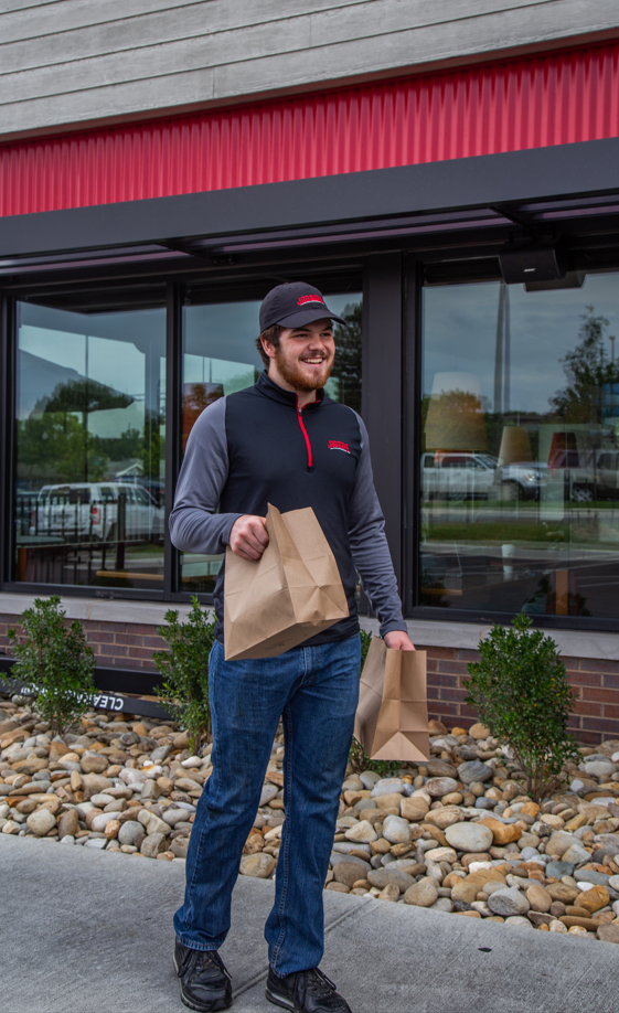 Food delivery picture of a person carrying take out